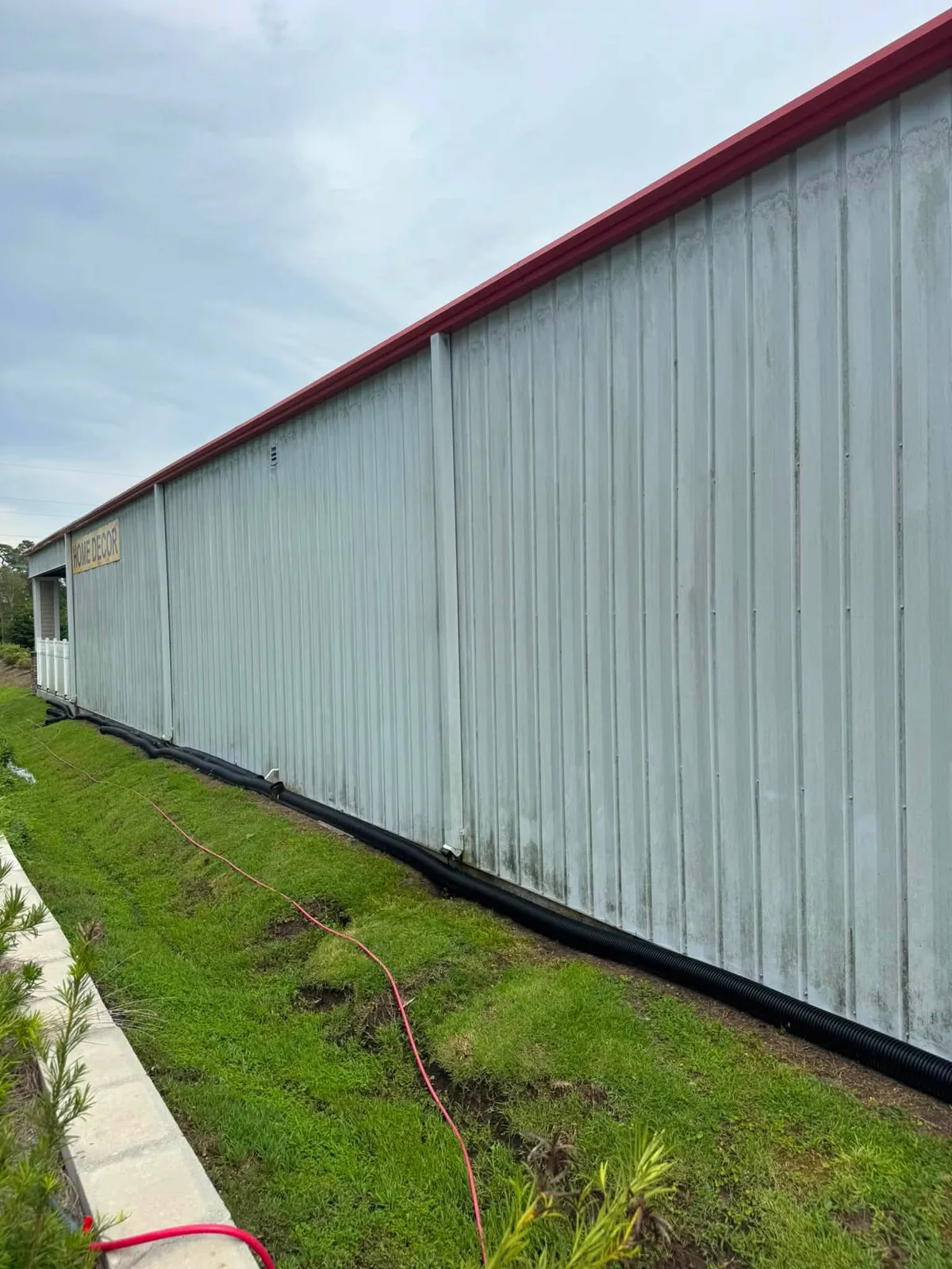 Stained commercial metal building wall before washing in Surf City NC