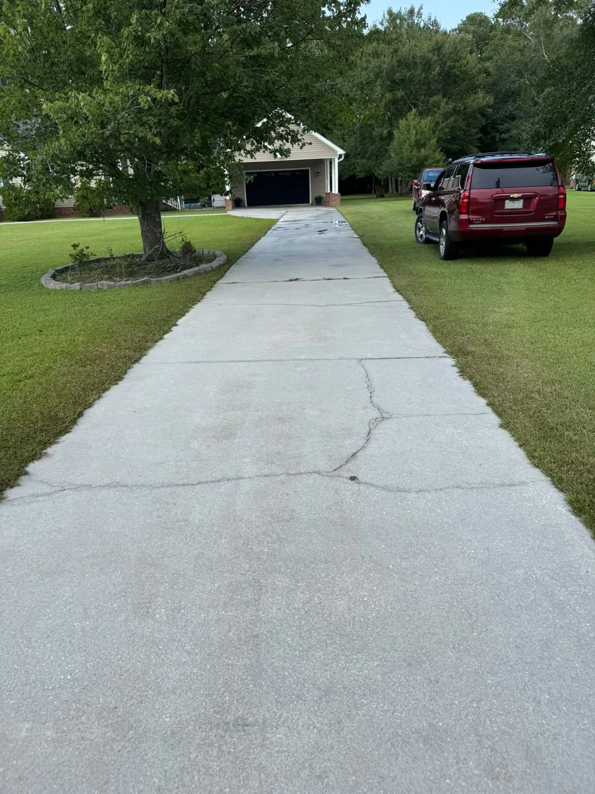 Same driveway bright and clean after pressure washing