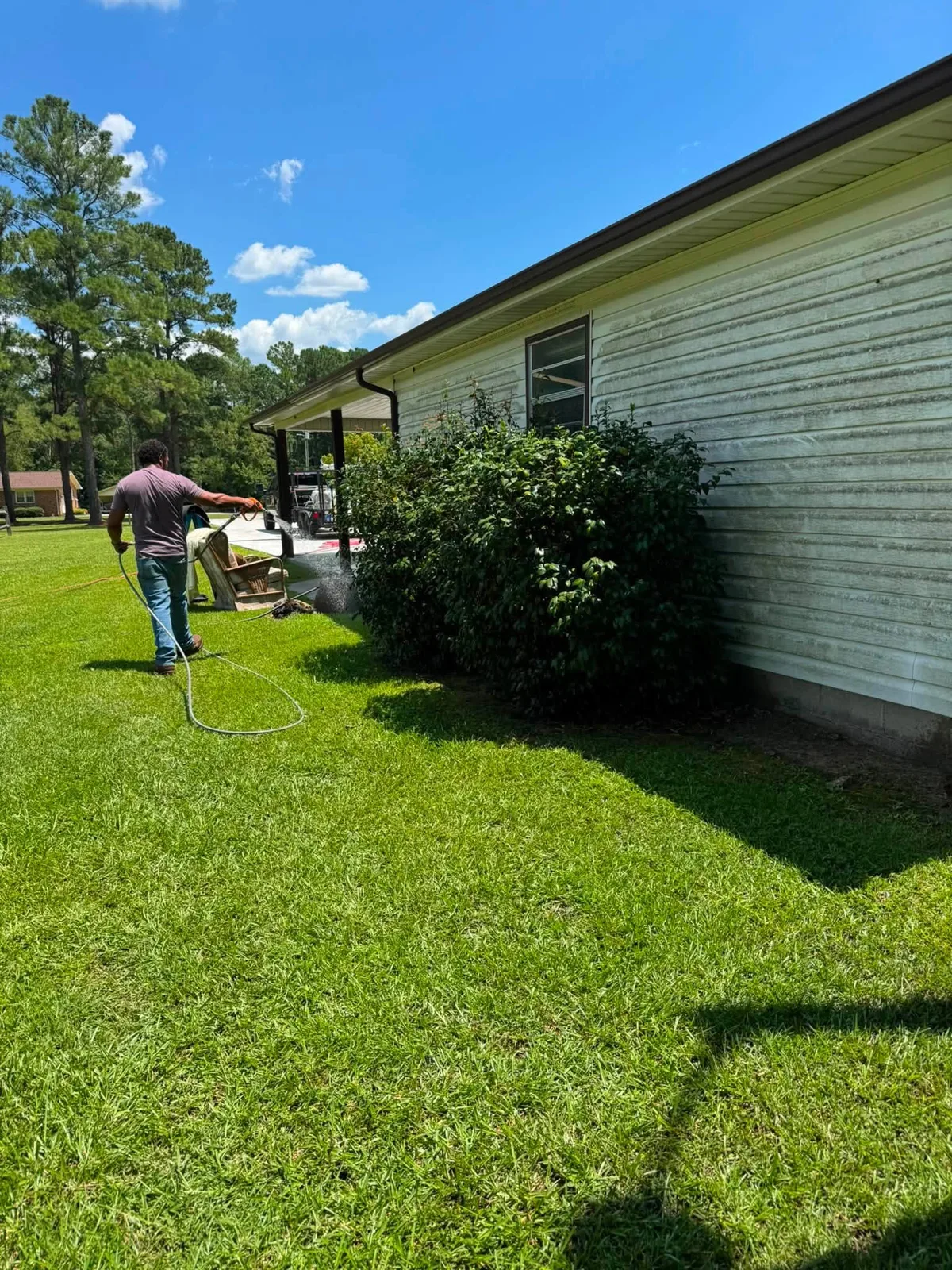 Soft washing vinyl siding on a newer North Carolina home
