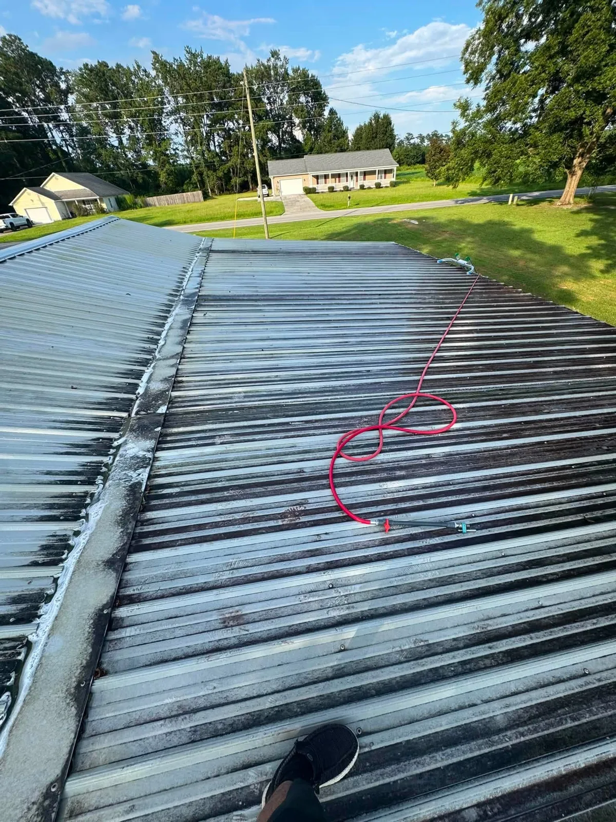 Dirty weathered metal roof before soft wash cleaning
